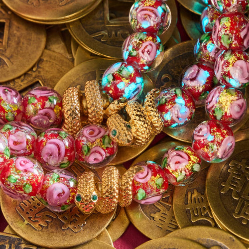 Golden Snake Firework Glass Rose Bracelet with red handblown beads and 18k gold plated snake charm on vintage gold coins by NOGU